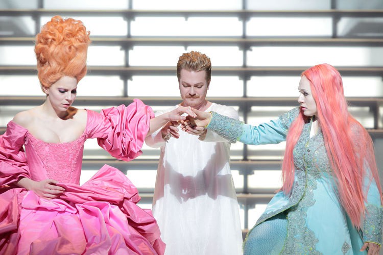 Act I: Servilia (left) and Annio (right), with Tito in the center. Note Annio's wig and gender-ambiguous costume. Also note Servilia's outrageous hair and hoop skirt.